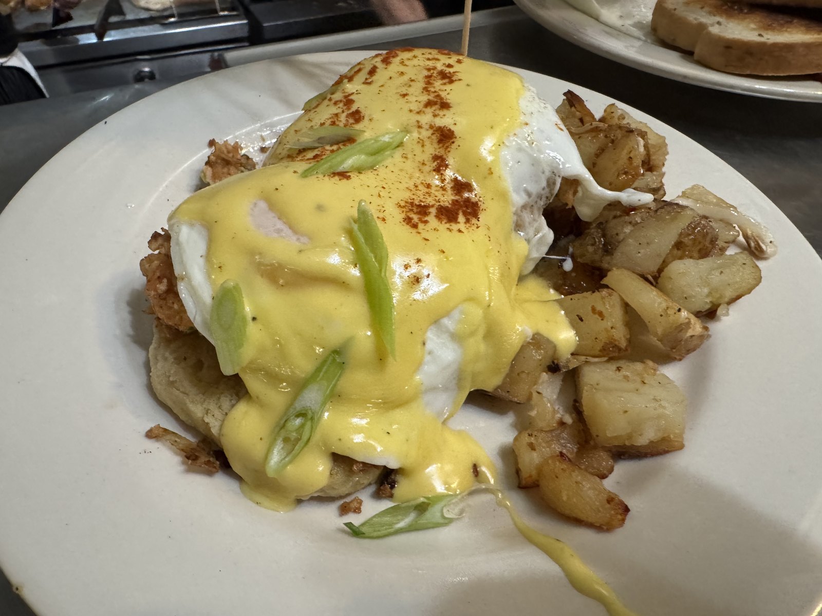Eggs Benedict with hollandaise and home fries