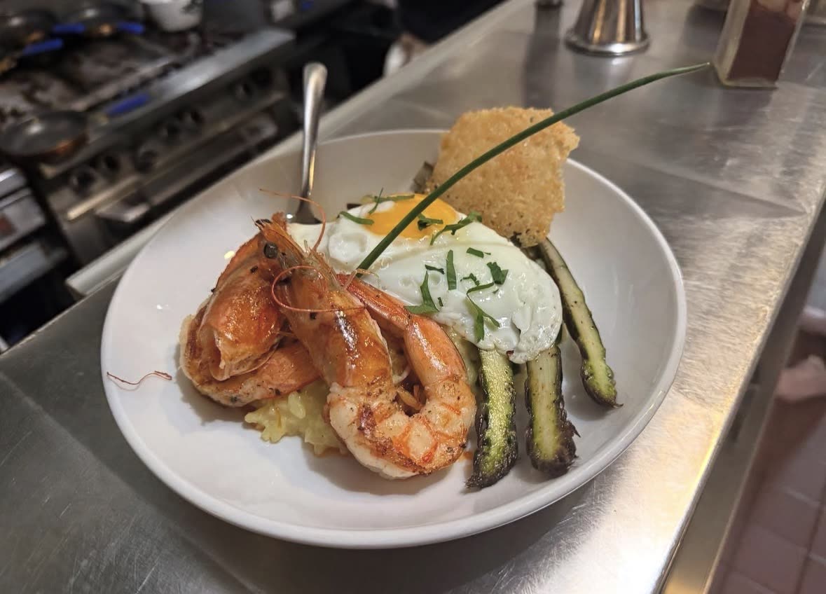 Shrimp over risotto with a fried egg, asparagus and a parmesan crisp